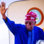 President Bola Tinubu speaking during an APC political event after the party waived his screening requirements for the 2027 primaries.