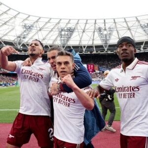 Arsenal players celebrate winning the 2026 Premier League title after Manchester City dropped points against Bournemouth.
