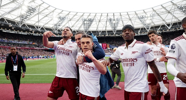 Arsenal players celebrate winning the 2026 Premier League title after Manchester City dropped points against Bournemouth.