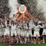 Aston Villa players celebrate after defeating Freiburg 3-0 in the Europa League final as Unai Emery lifts the trophy.