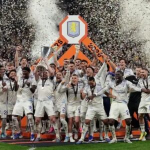 Aston Villa players celebrate after defeating Freiburg 3-0 in the Europa League final as Unai Emery lifts the trophy.