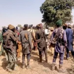 File photo depicting armed bandits as Residents gathered in rural Zamfara community setting in Maradun LGA, illustrating insecurity and rural displacement in north-west Nigeria.