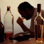 Illustration of alcoholic drinks beside medical symbols highlighting health risks linked to alcohol consumption.