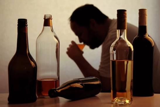 Illustration of alcoholic drinks beside medical symbols highlighting health risks linked to alcohol consumption.