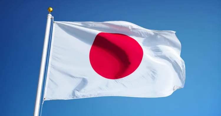 Japanese flag waving outside a government building as Japan tightens student visa and documentation requirements for foreign students.