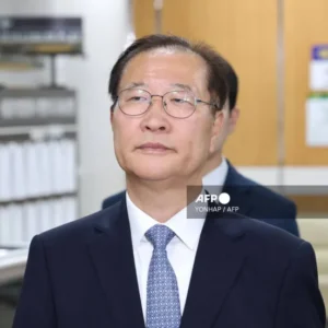 Former South Korean justice minister escorted after sentencing outside Seoul court following 2024 martial law-related conviction.