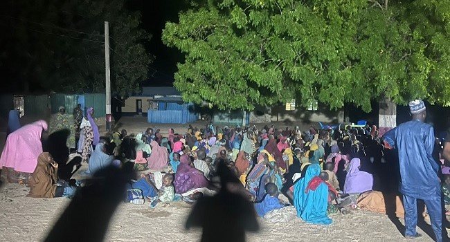 Rescued women and children receive assistance from Nigerian military personnel after being freed from a Boko Haram enclave in the Mandara Mountains, Borno State.