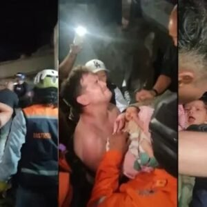 Rescue workers carry a newborn baby after pulling the infant alive from the rubble of a collapsed building in La Guaira following the Venezuela earthquakes.