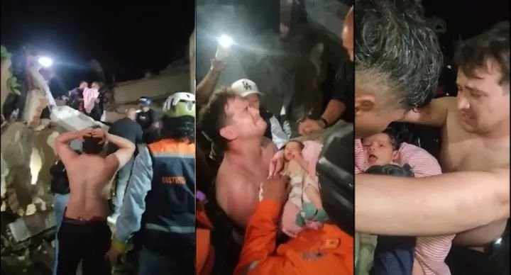 Rescue workers carry a newborn baby after pulling the infant alive from the rubble of a collapsed building in La Guaira following the Venezuela earthquakes.