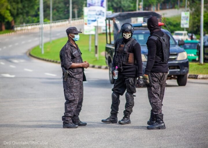 DSS operatives arrest five suspects linked to the Papiri Catholic school abduction as security agents display recovered rifles and ammunition.