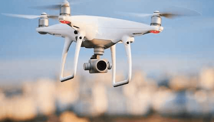 A conceptual illustration of drone surveillance and AI monitoring over Nigeria’s border regions, showing digital mapping, sensors and security command centres.