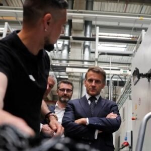 Emmanuel Macron visiting a factory during Choose France event ahead of global summit focused on AI and data centre investment in France.