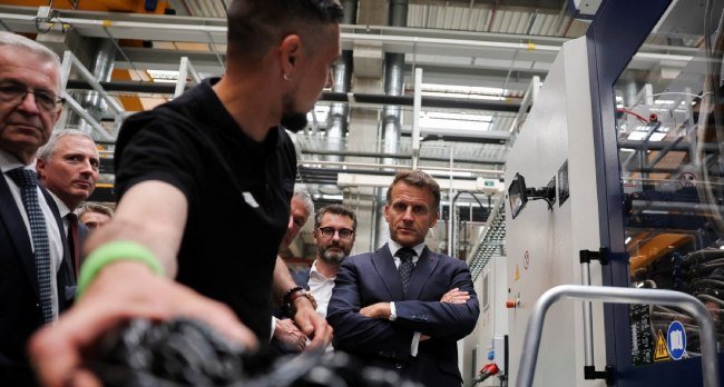Emmanuel Macron visiting a factory during Choose France event ahead of global summit focused on AI and data centre investment in France.