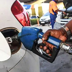 Fuel attendant dispensing petrol into a vehicle at a filling station in Nigeria as PETROAN calls for lower fuel prices following a decline in global crude oil prices.