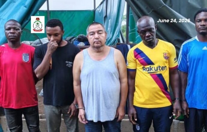 NDLEA officials display suspects and recovered equipment after uncovering an industrial-scale methamphetamine laboratory in Oyo State.