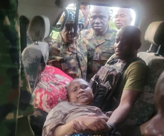 Nigerian troops evacuating a rescued the late general's wife to a military medical facility after a counter-offensive operation in Katsina State.