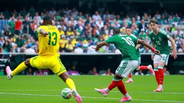 Mexico players celebrating a goal during World Cup opener at Estadio Azteca, with South Africa players reacting after a red card decision.