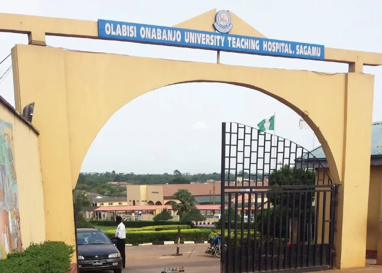 Resident doctors protesting at Olabisi Onabanjo University Teaching Hospital entrance in Sagamu during a warning strike announcement.
