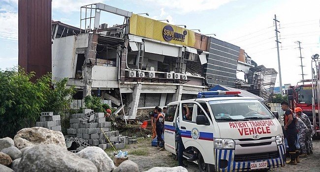 Rescue workers search through collapsed buildings in General Santos City after a powerful 7.8-magnitude earthquake struck southern Philippines, killing at least 15 people and triggering tsunami warnings.