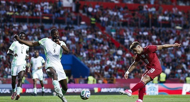 Nigeria Super Eagles and Portugal players contesting an international friendly match in Leiria, with Portugal scoring a late winning goal.