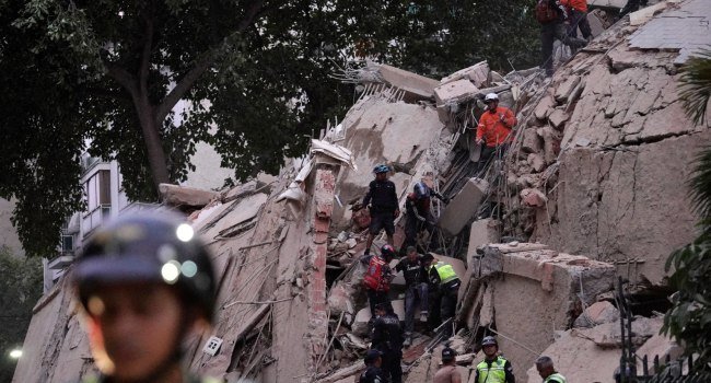 Rescue workers search through the rubble of a collapsed building in Caracas after twin earthquakes struck Venezuela, killing dozens and injuring hundreds.