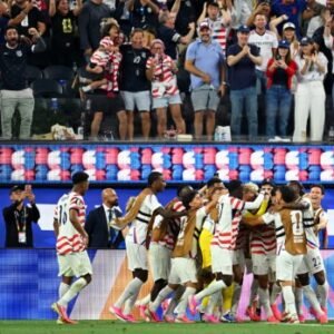 USA midfielder Giovanni Reyna celebrates with teammates after scoring during the FIFA World Cup 2026 group-stage match against Paraguay in Los Angeles.