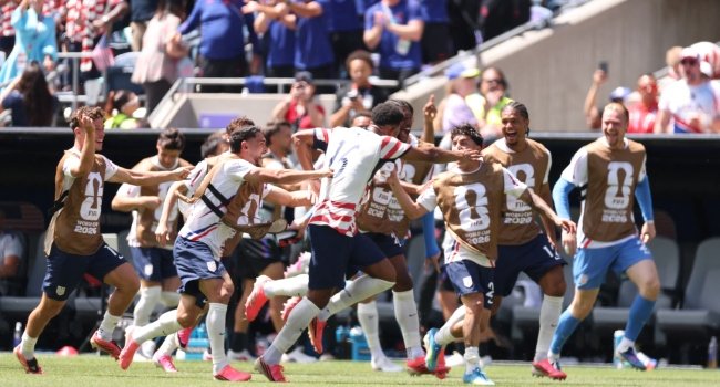 USA players celebrating a goal against Australia during their 2-0 World Cup 2026 victory in Seattle.