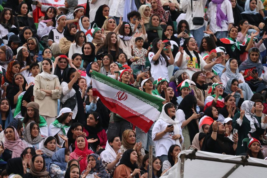 Iranian football supporters at a stadium during an international match, representing World Cup fan attendance concerns.