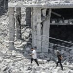 Damaged market scene in southern Lebanon with residents returning amid ongoing Israel-Hezbollah clashes and heightened regional tensions reported under US-Iran deal strain.