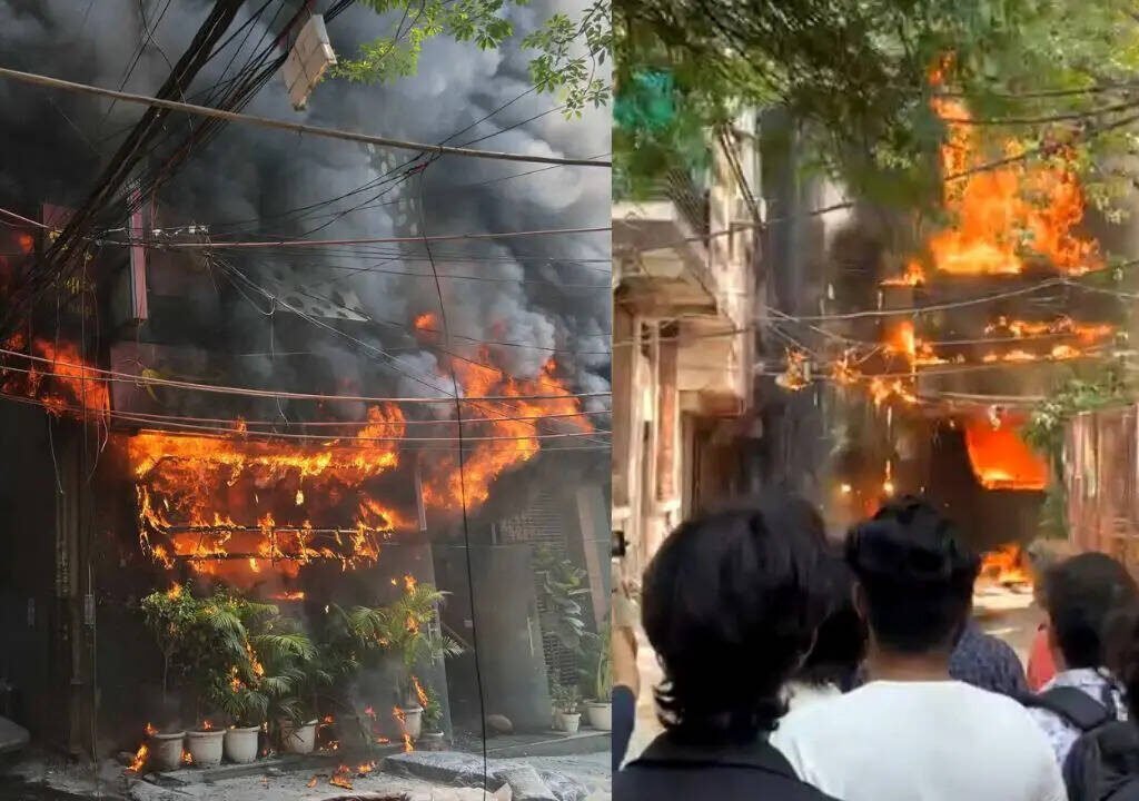 Firefighters and emergency responders at the scene of a deadly hotel fire in New Delhi's Malviya Nagar neighbourhood.