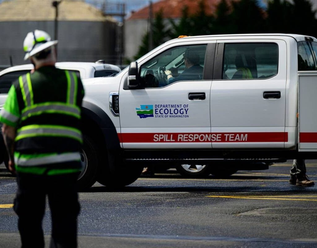 Emergency response vehicles outside the Nippon Dynawave Packaging plant in Longview, Washington, following a fatal chemical tank implosion that killed 11 workers.