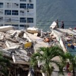 Rescue workers search through the rubble of a collapsed building in La Guaira, Venezuela, following the devastating June 2026 earthquakes.