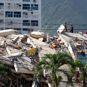 Rescue workers search through the rubble of a collapsed building in La Guaira, Venezuela, following the devastating June 2026 earthquakes.