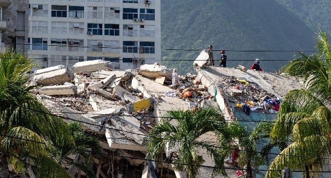 Rescue workers search through the rubble of a collapsed building in La Guaira, Venezuela, following the devastating June 2026 earthquakes.