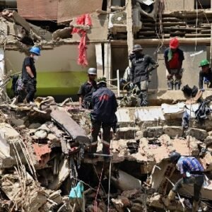 Rescue workers search through the rubble of a collapsed building in La Guaira, Venezuela, following the devastating June 24 earthquakes that have killed more than 3,500 people.