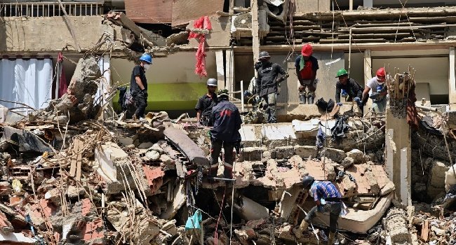 Rescue workers search through the rubble of a collapsed building in La Guaira, Venezuela, following the devastating June 24 earthquakes that have killed more than 3,500 people.