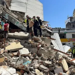 Rescuers search through rubble after a powerful earthquake in Pereira, Colombia.