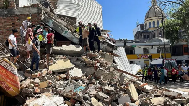 Rescuers search through rubble after a powerful earthquake in Pereira, Colombia.