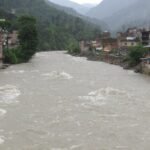Floodwaters and mud sweep through a Nepalese community near the Tibet border after a deadly flash flood.
