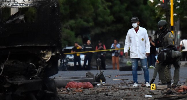 Police inspect the wreckage of an explosives-laden truck after a bombing near a police station in Cucuta, Colombia, ahead of the presidential inauguration.