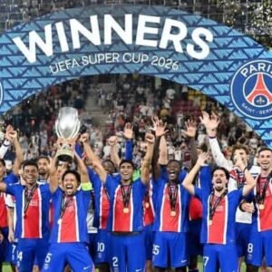 PSG players celebrate after beating Aston Villa to retain the UEFA Super Cup. PSG's Marquinhos lifts the trophy with teammates after winning the UEFA Super Cup REUTERS/Angelika Warmuth