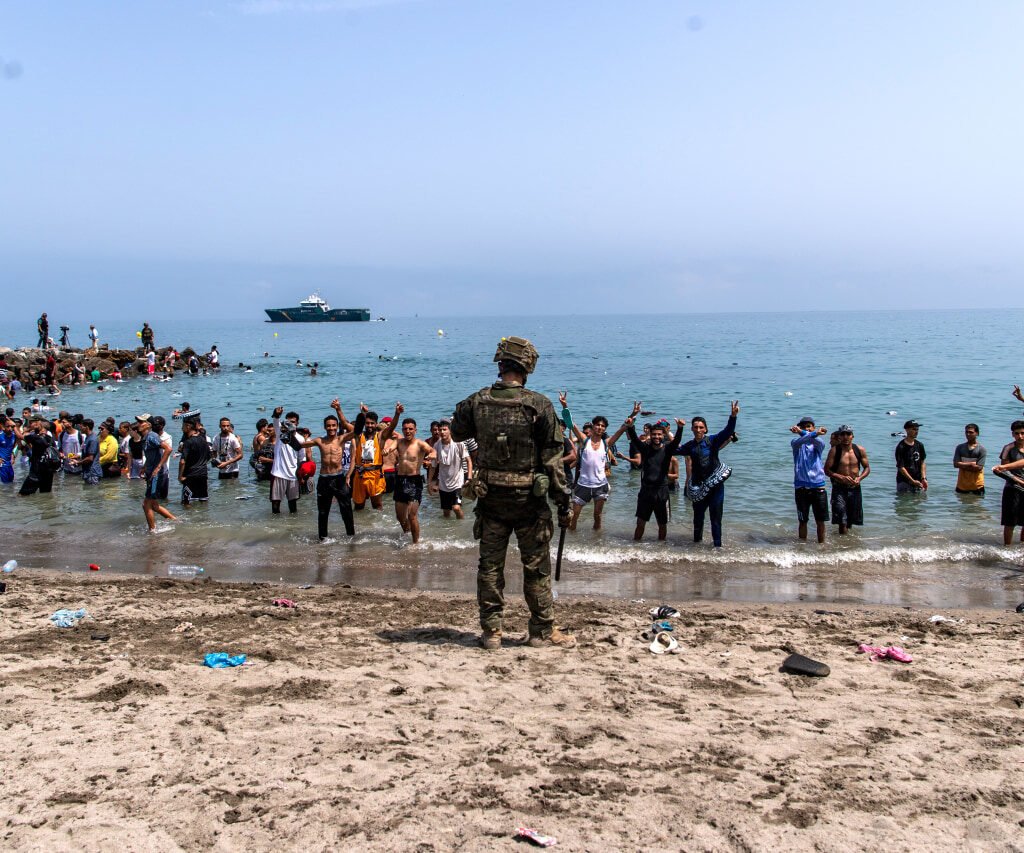 Migrants swimming from Morocco towards Spain's North African enclave of Ceuta during the mass border crossing.
