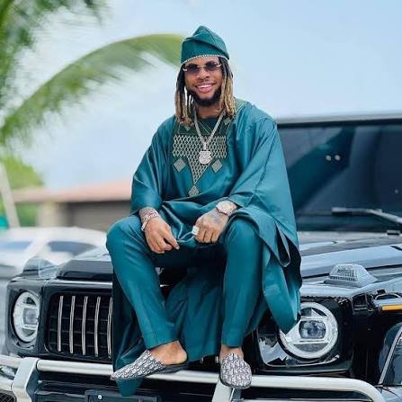 Nigerian dancer and hypeman Poco Lee smiling at an event.