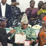 Governor Ademola Adeleke receiving his Certificate of Return from INEC after winning the Osun State governorship election.