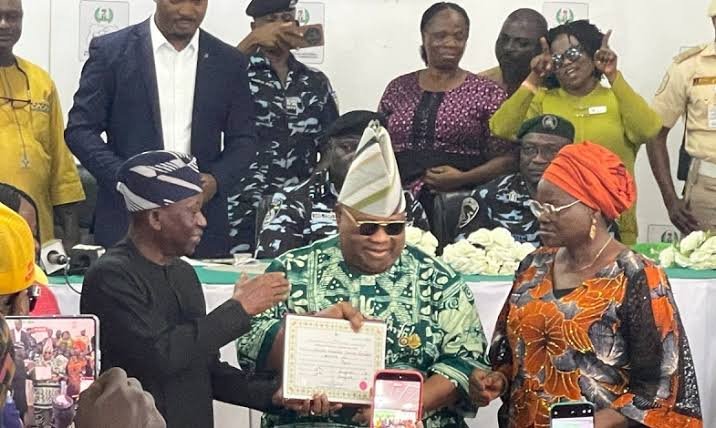 Governor Ademola Adeleke receiving his Certificate of Return from INEC after winning the Osun State governorship election.