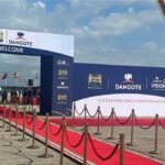 Dangote East Africa Petroleum Refinery groundbreaking ceremony in Lamu, Kenya, with tractors and guests at the project site.