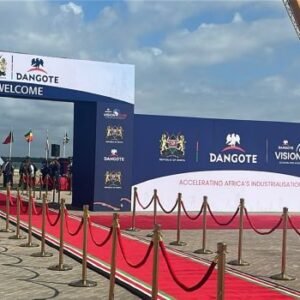 Dangote East Africa Petroleum Refinery groundbreaking ceremony in Lamu, Kenya, with tractors and guests at the project site.
