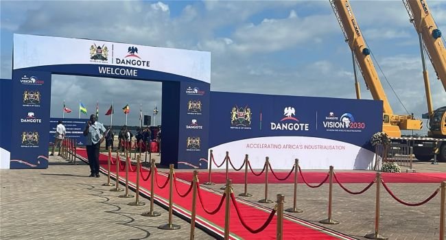 Dangote East Africa Petroleum Refinery groundbreaking ceremony in Lamu, Kenya, with tractors and guests at the project site.