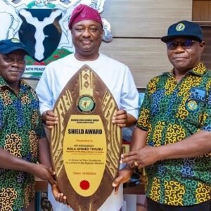 Festus Keyamo displays the NCSU Shield Award presented to President Bola Tinubu for workers’ welfare in Abuja.