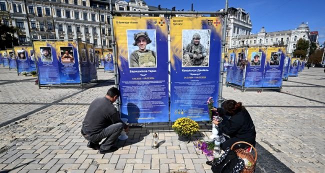 Ukrainian officials receive repatriated bodies returned from Russia in a war dead exchange.
